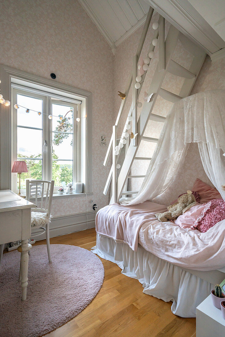 Bed below ladder leading to gallery in charming girl's bedroom