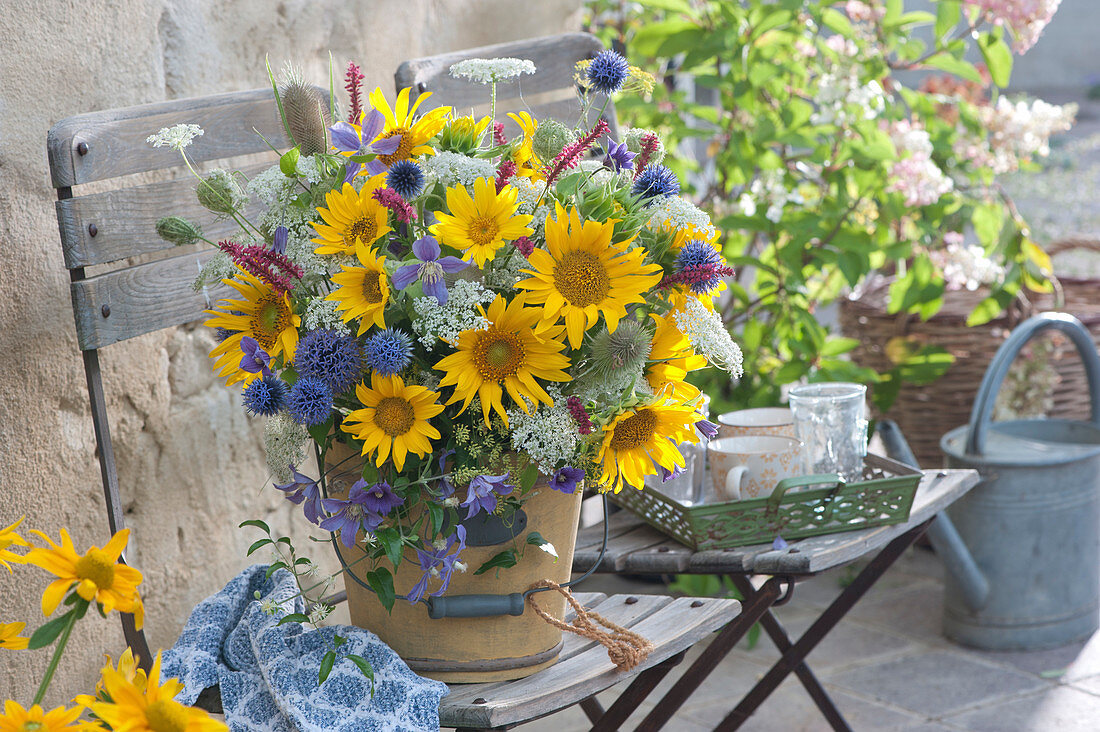 Bouquet from the farm garden: sunflowers, ball thistles, wild carrot, clematis, knotweed and wild teasel
