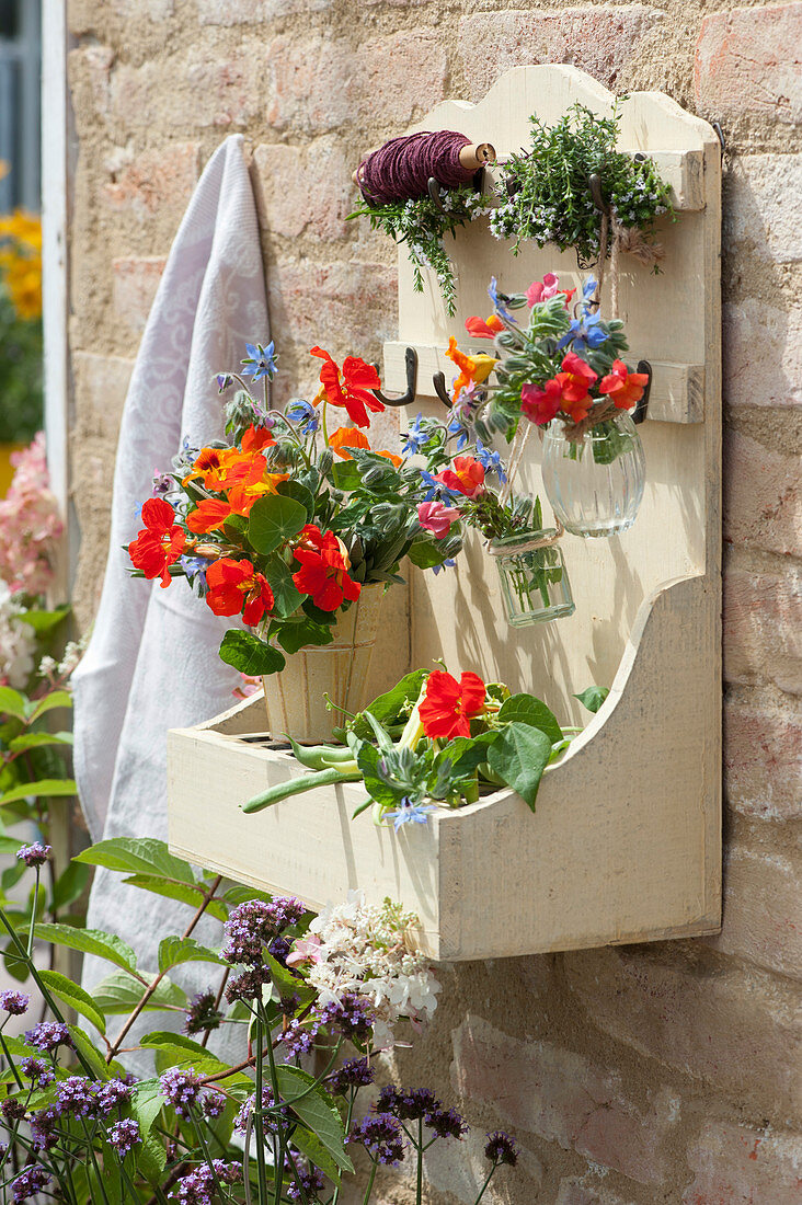 Wall hanger with bouquets of nasturtiums, borage, snapdragons, savoury and beans