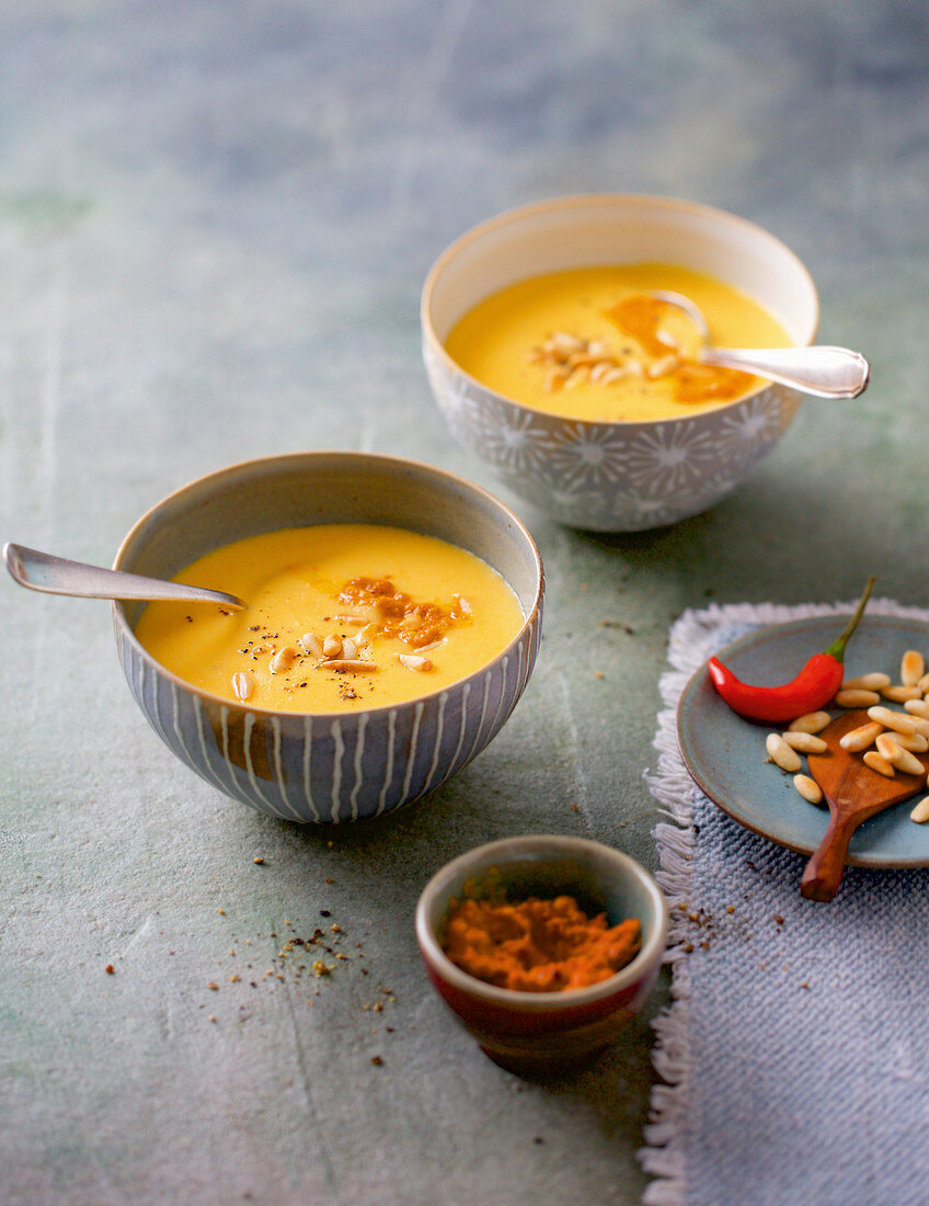 Cream of potato soup with orange and curried pine seeds