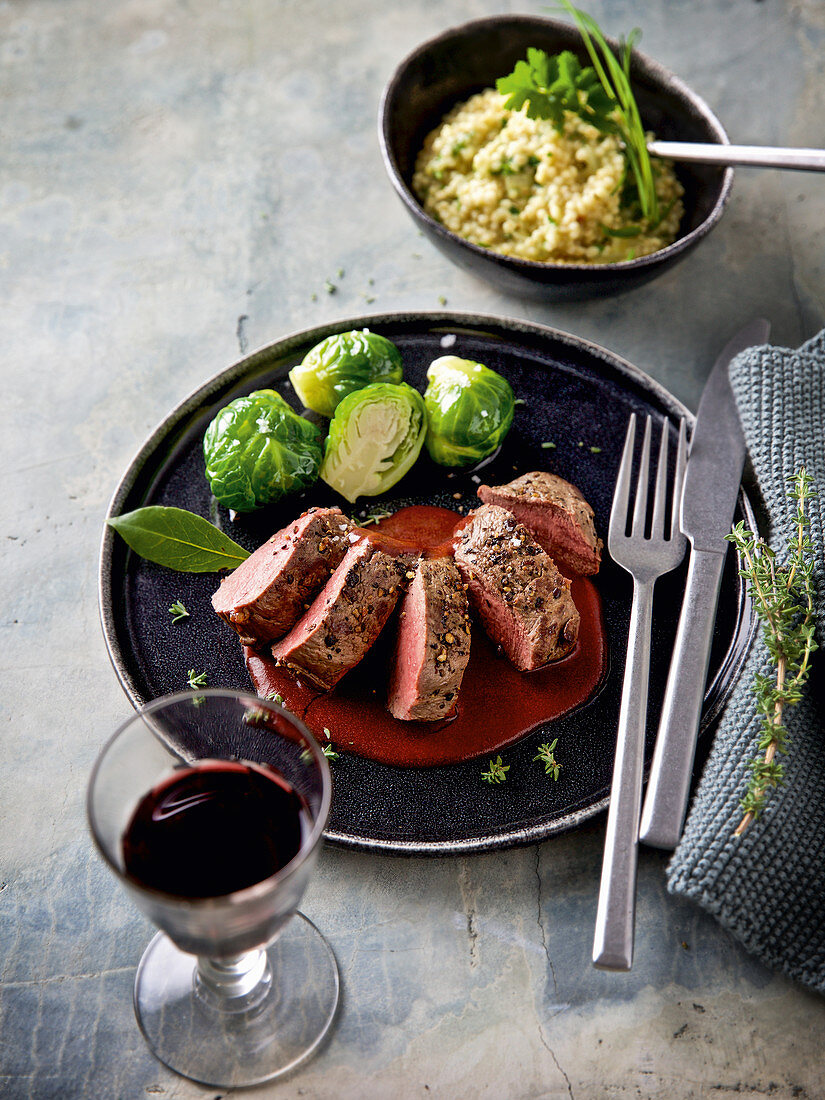 A saddle of venison à la minute with barley and herb risotto and brussels sprouts