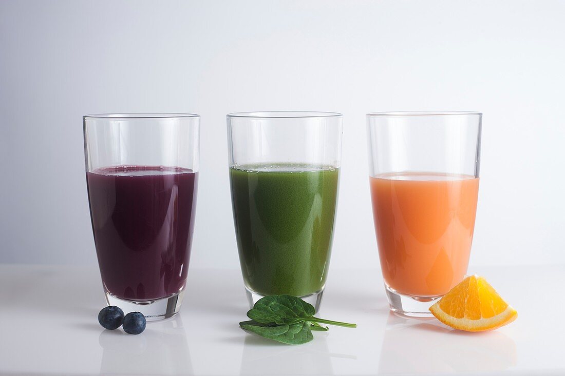 Fresh juices made of berries,oranges and green leaves
