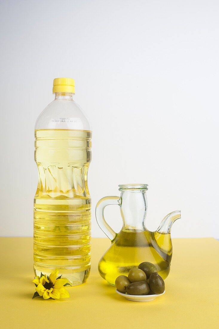 Bottle of sunflower oil and jug of olive oil
