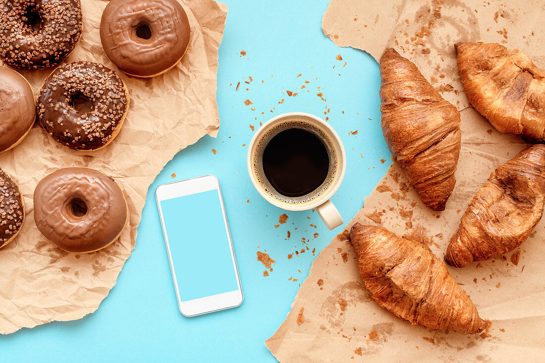 Coffee,croissants and doughnuts with smart phone