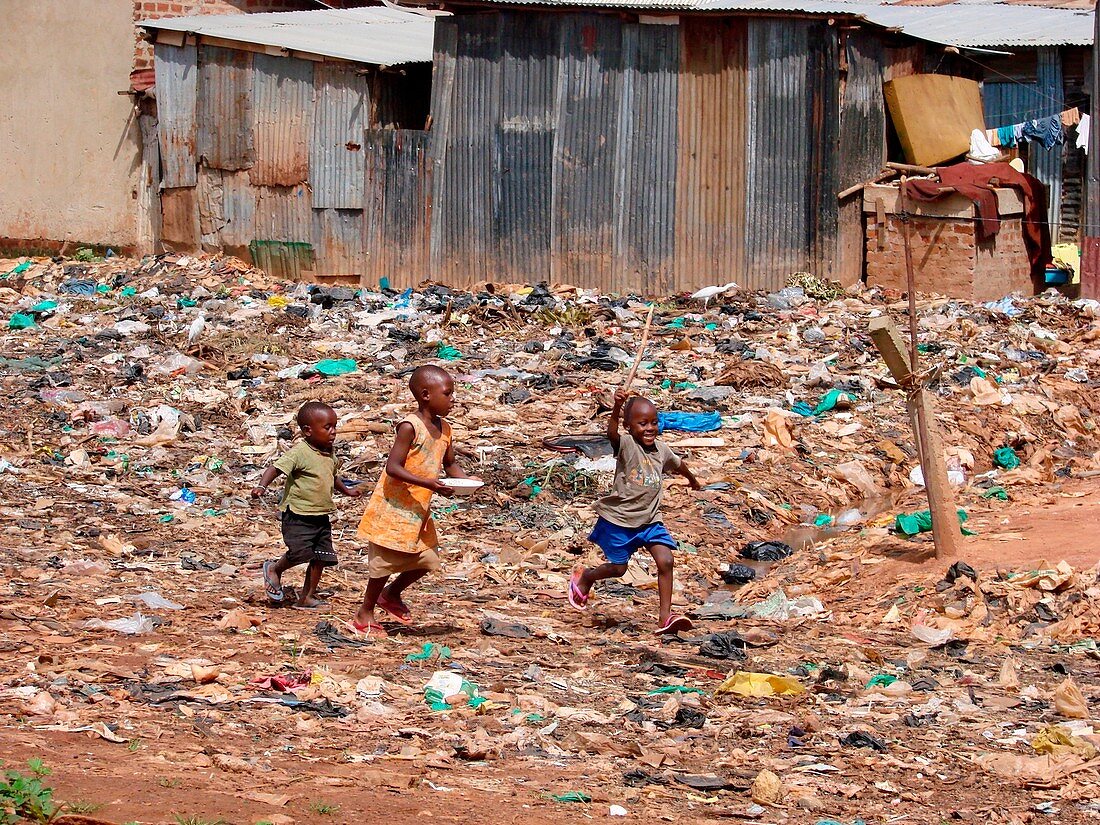 Children playing amongst refuse, Uganda