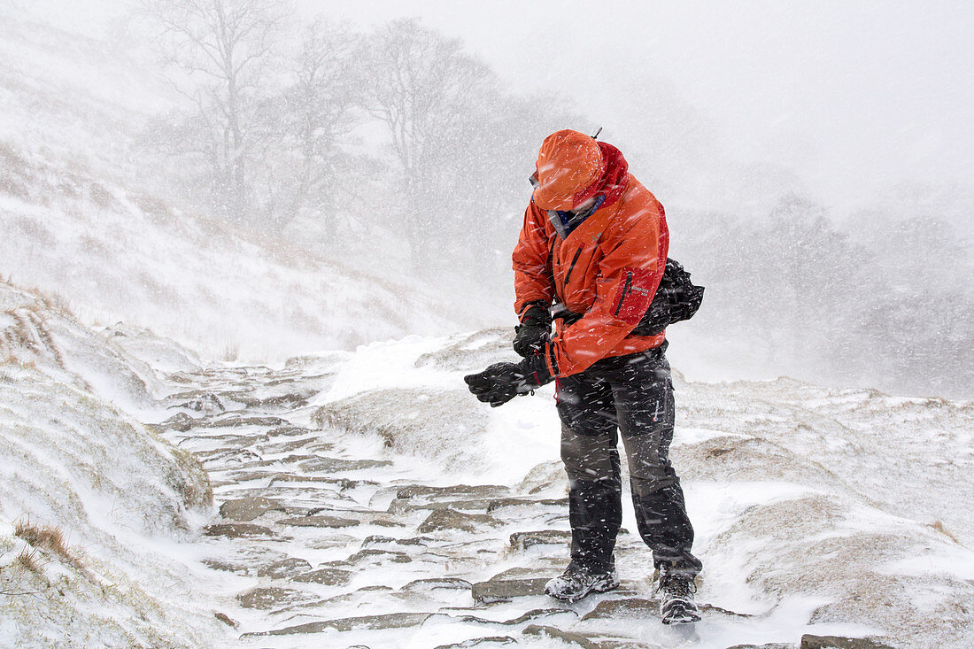 Man in snow storm, Lake District, UK