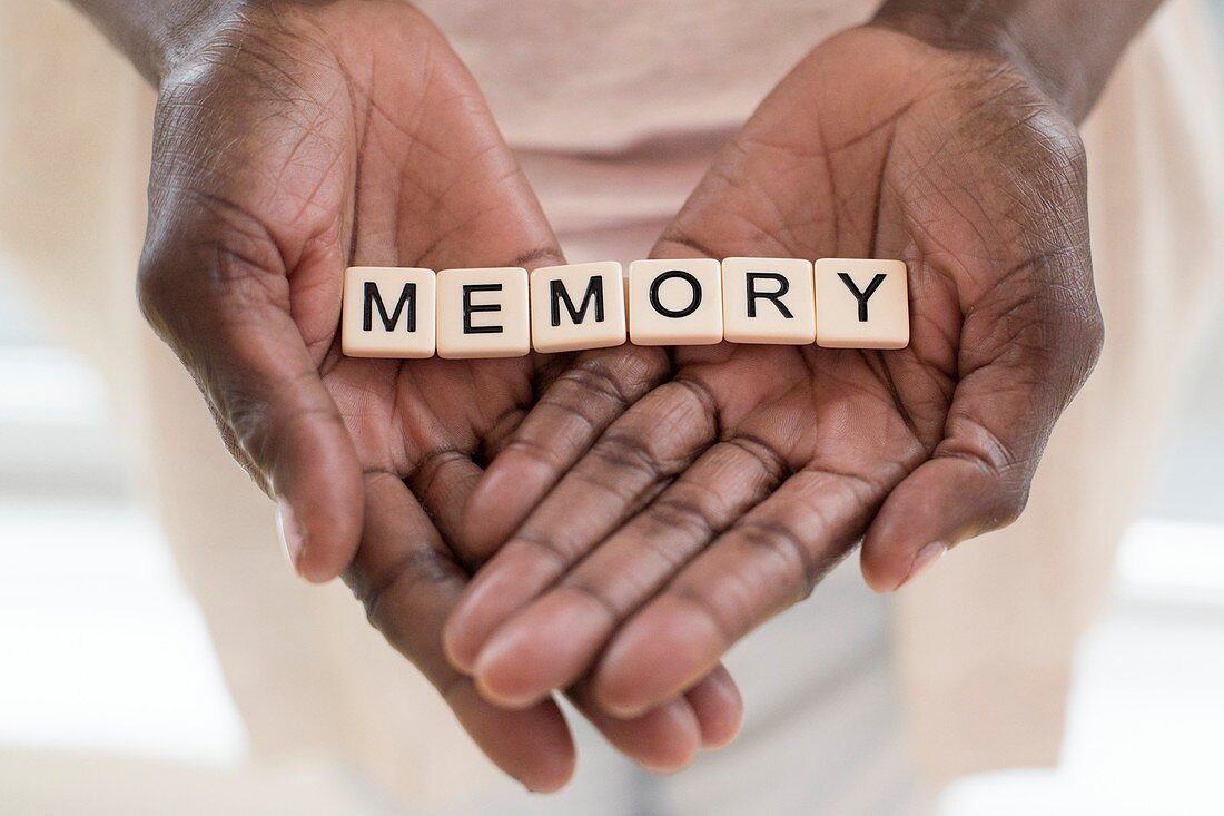 Woman holding word memory