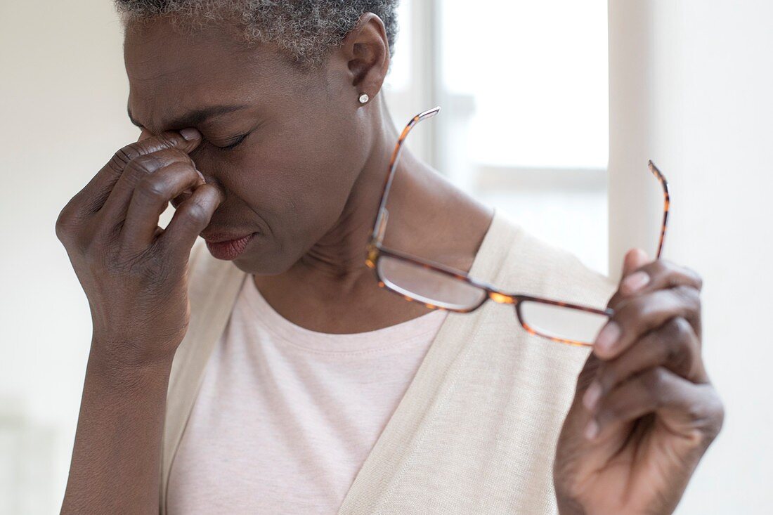 Woman touching bridge of nose