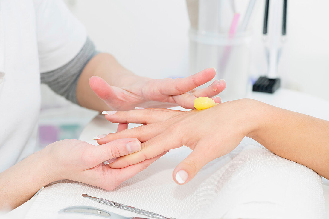 Hand cream application during manicure