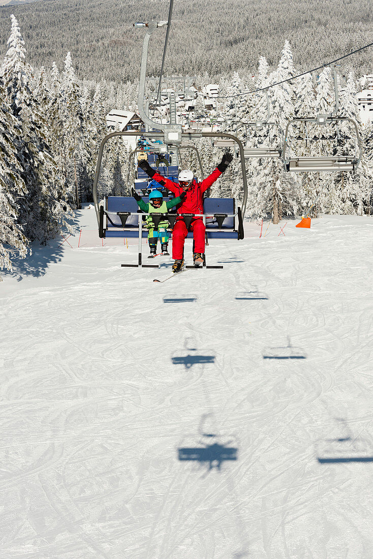 Boy with ski instructor on ski lift