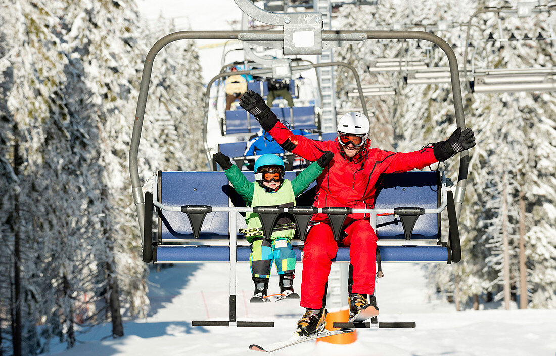 Boy with ski instructor on ski lift