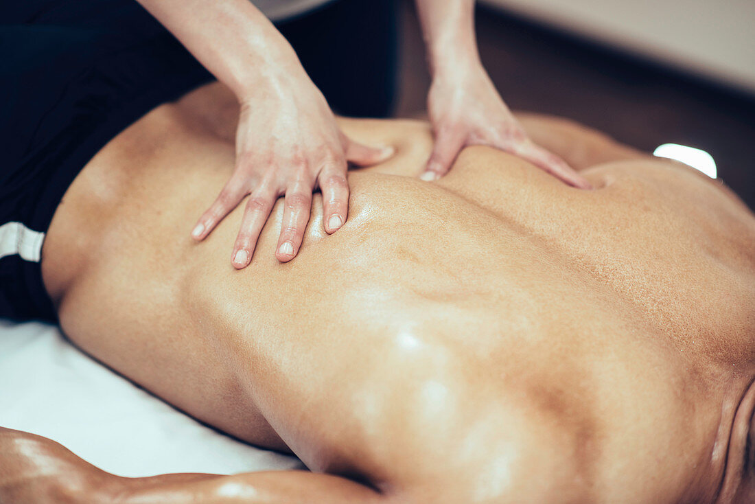 Physical therapist massaging back