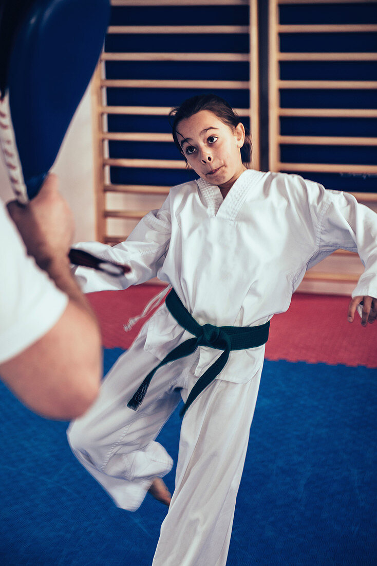 Taekwondo instructor working with girl