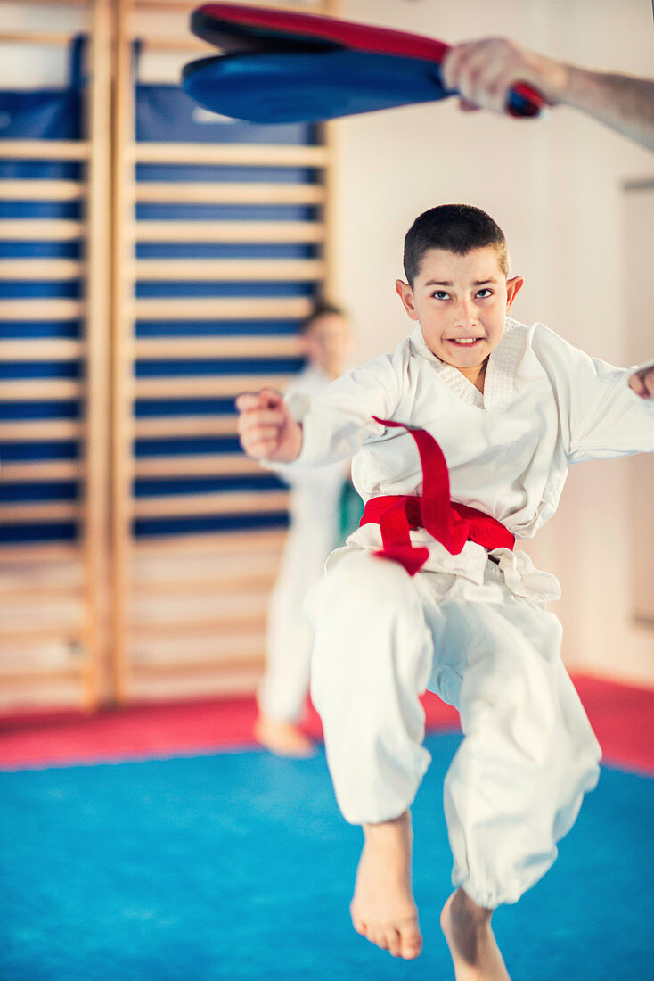 Taekwondo instructor working with boy