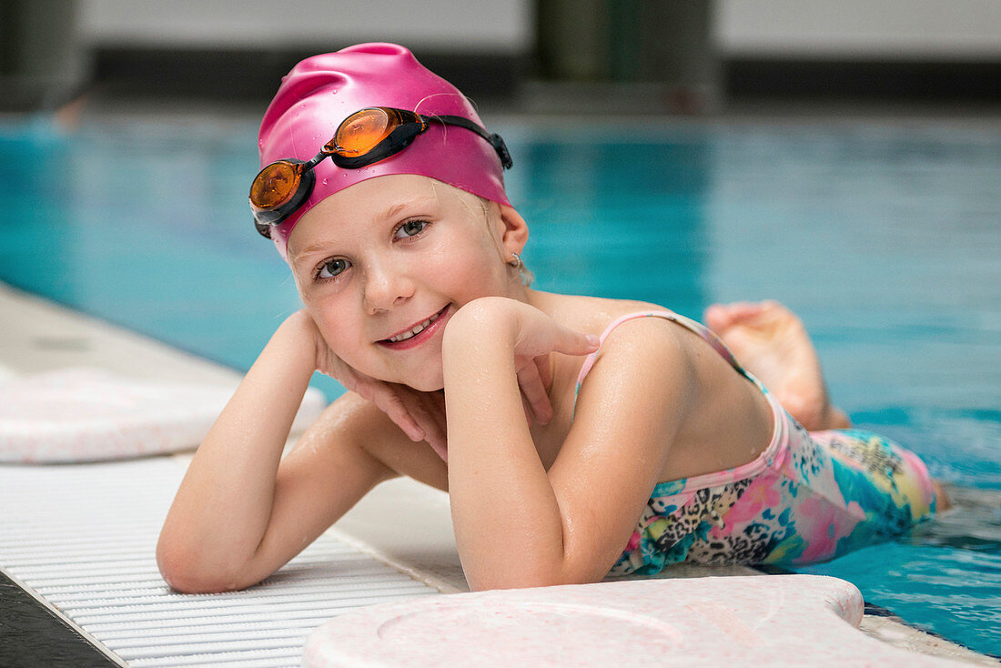 Girl posing on swimming pool edge