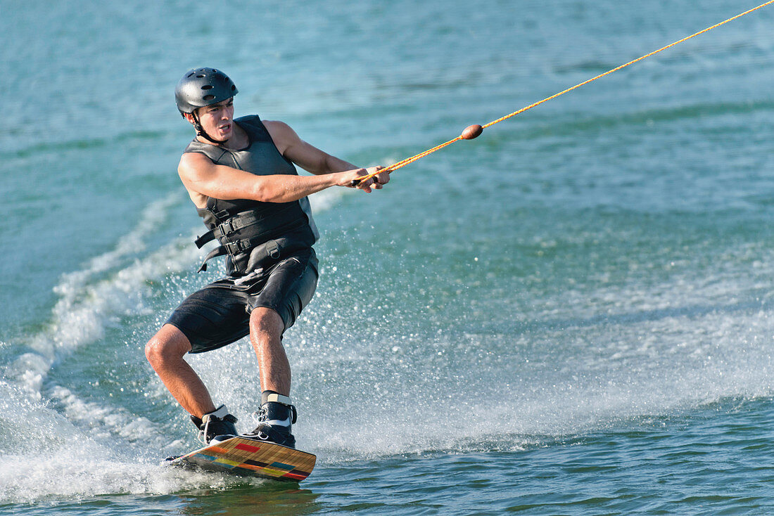 Young man wakeboarding