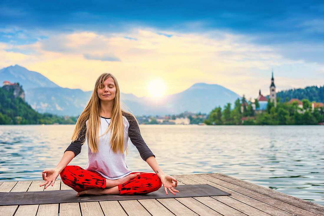 Woman doing yoga by a lake