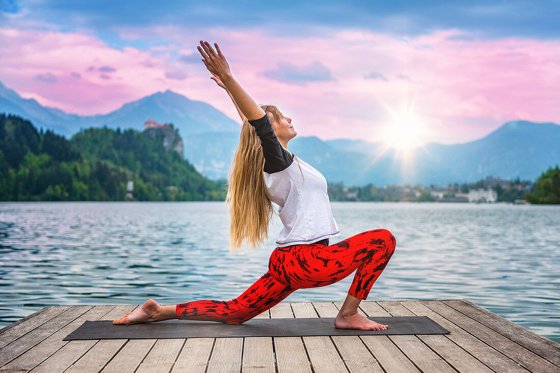 Woman doing yoga by a lake