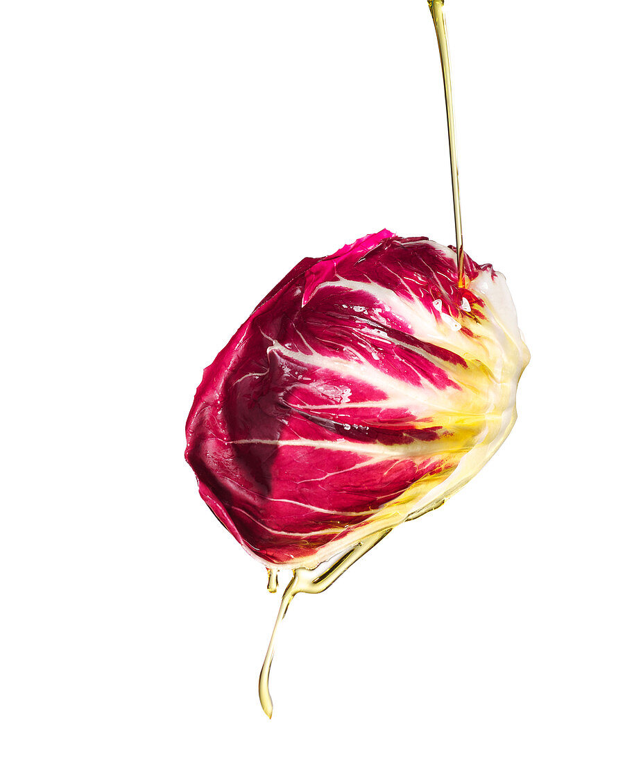 Oil pouring on radicchio leaf