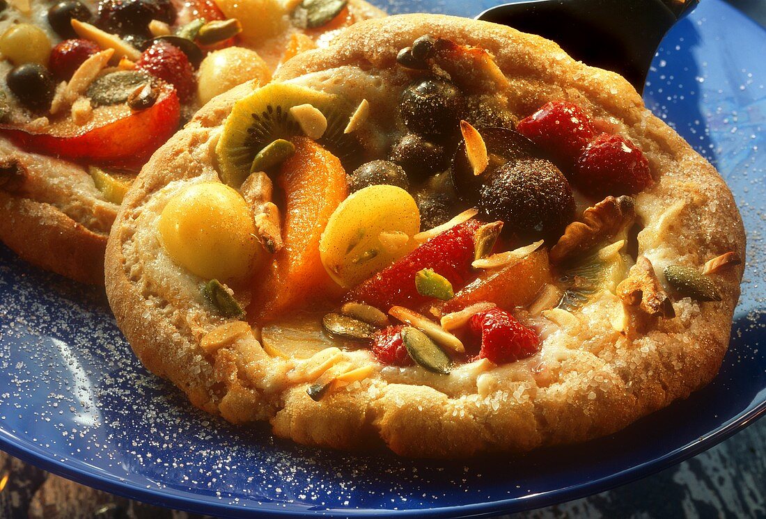 Sweet fruit pizzas with fruit and nuts