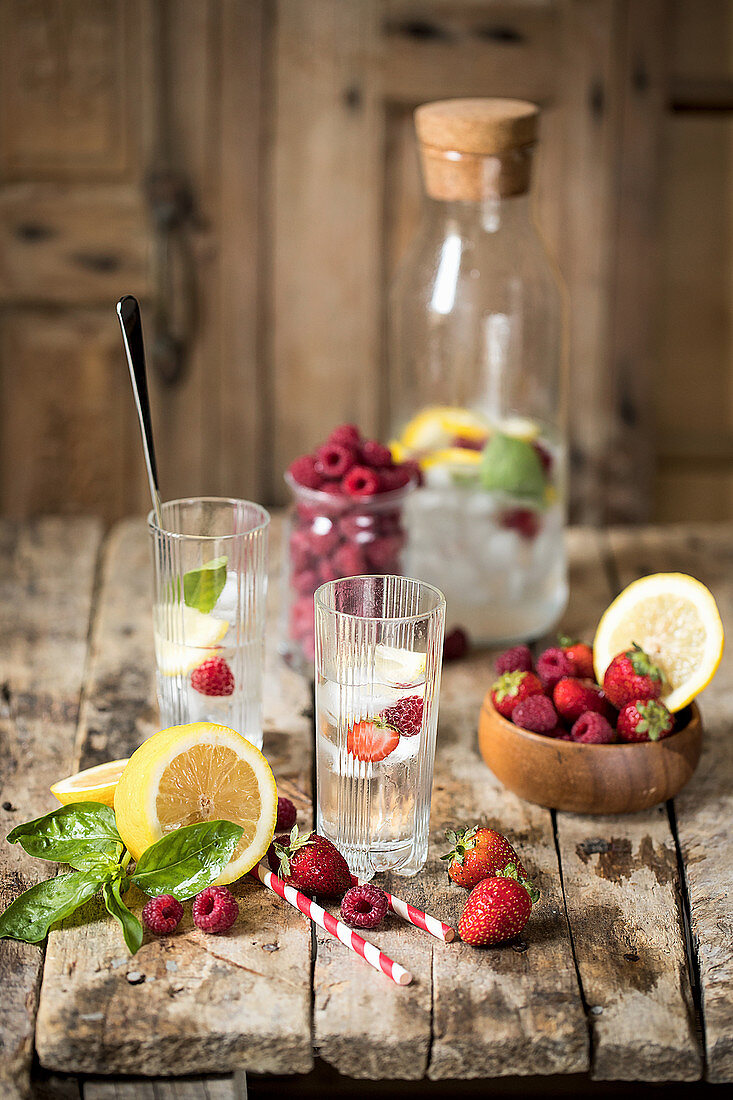 Flavoured water with berries, lemon and ice cubes