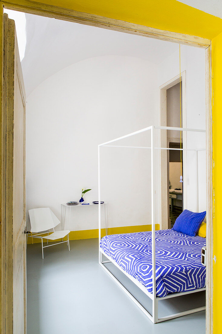 View into bedroom with yellow and blue accents