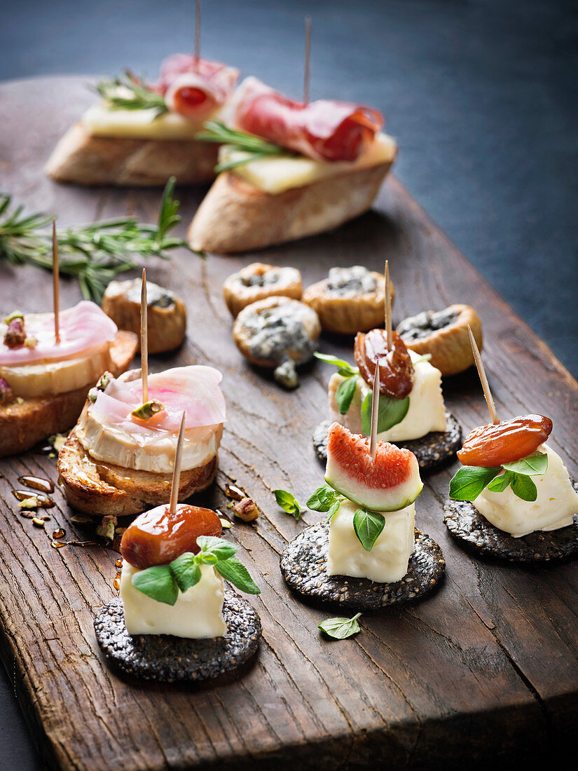 Various appetizers on wooden board