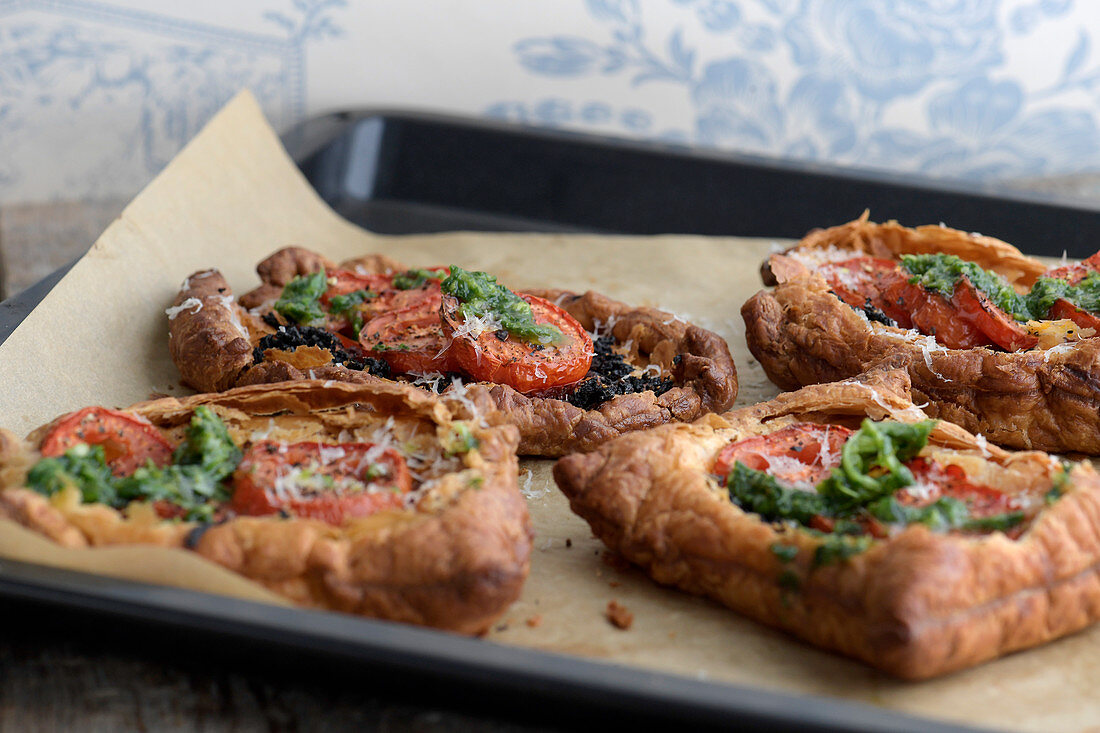 Tomato galette topped with tomatoes and basil oil