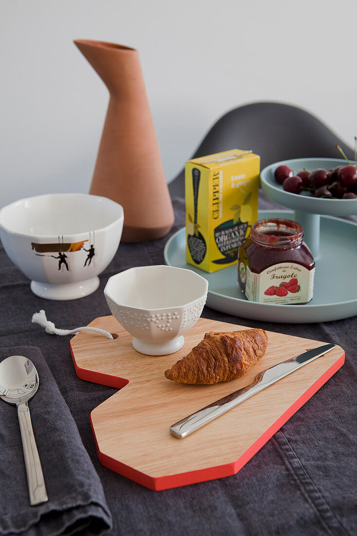 Breakfast place setting with heart-shaped wooden board