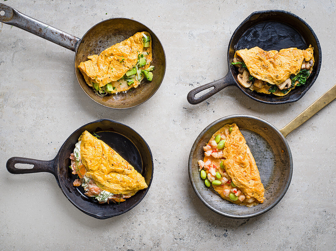 Four omelette varieties with salmon, avocado, spinach and mushrooms, Asian spicy prawns