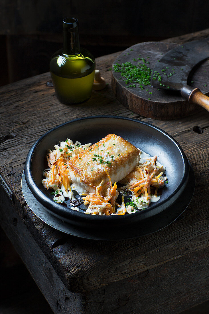 Fried wolffish served with sauerkraut and pumpkin