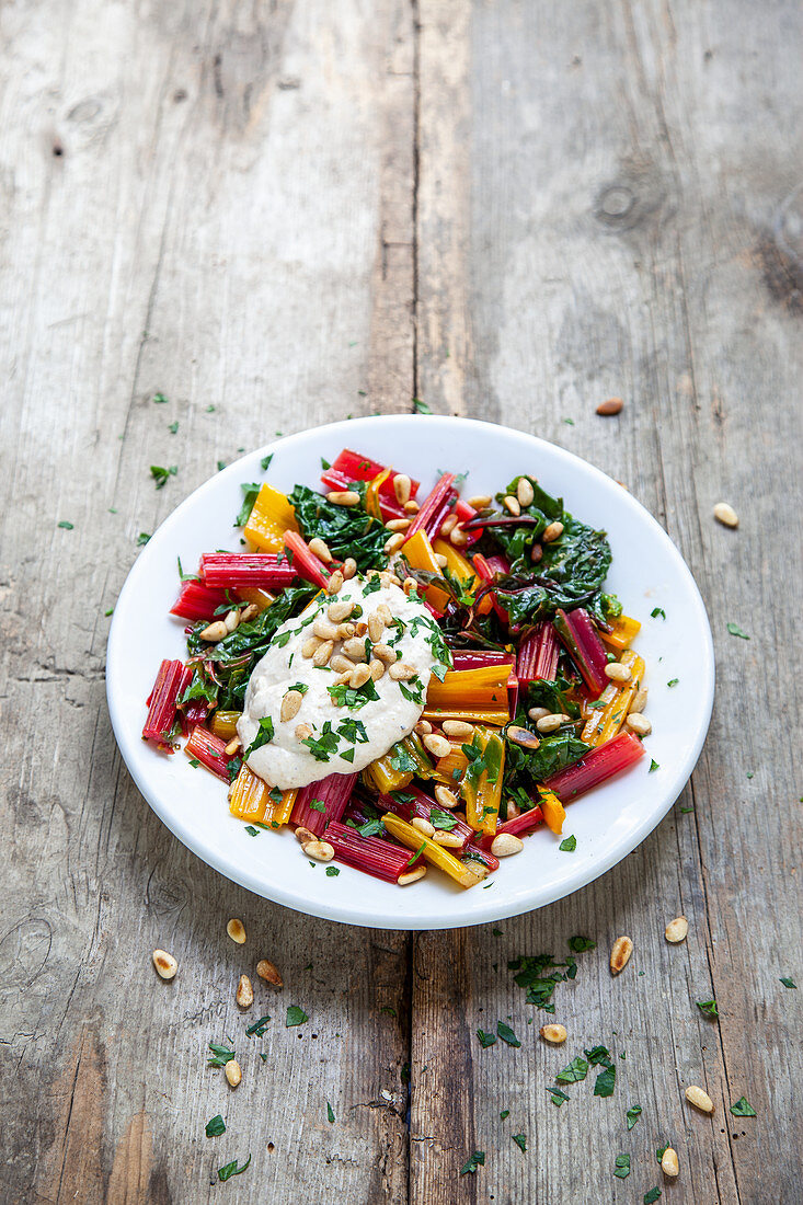 Colourful chard with sesame seed sauce and pine nuts