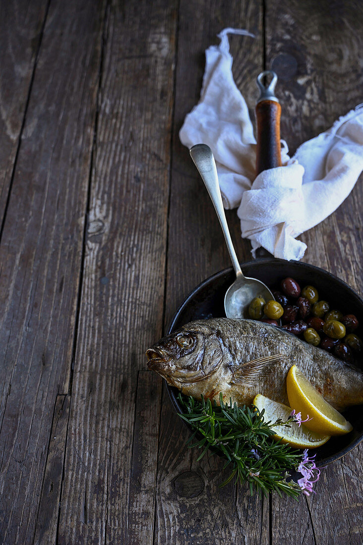 Whole roasted cape bream with olives and citrus