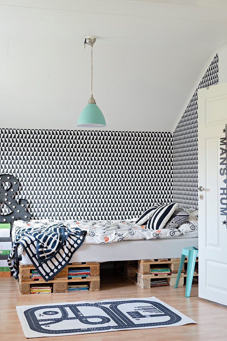 Black-and-white graphic wallpaper in child's bedroom