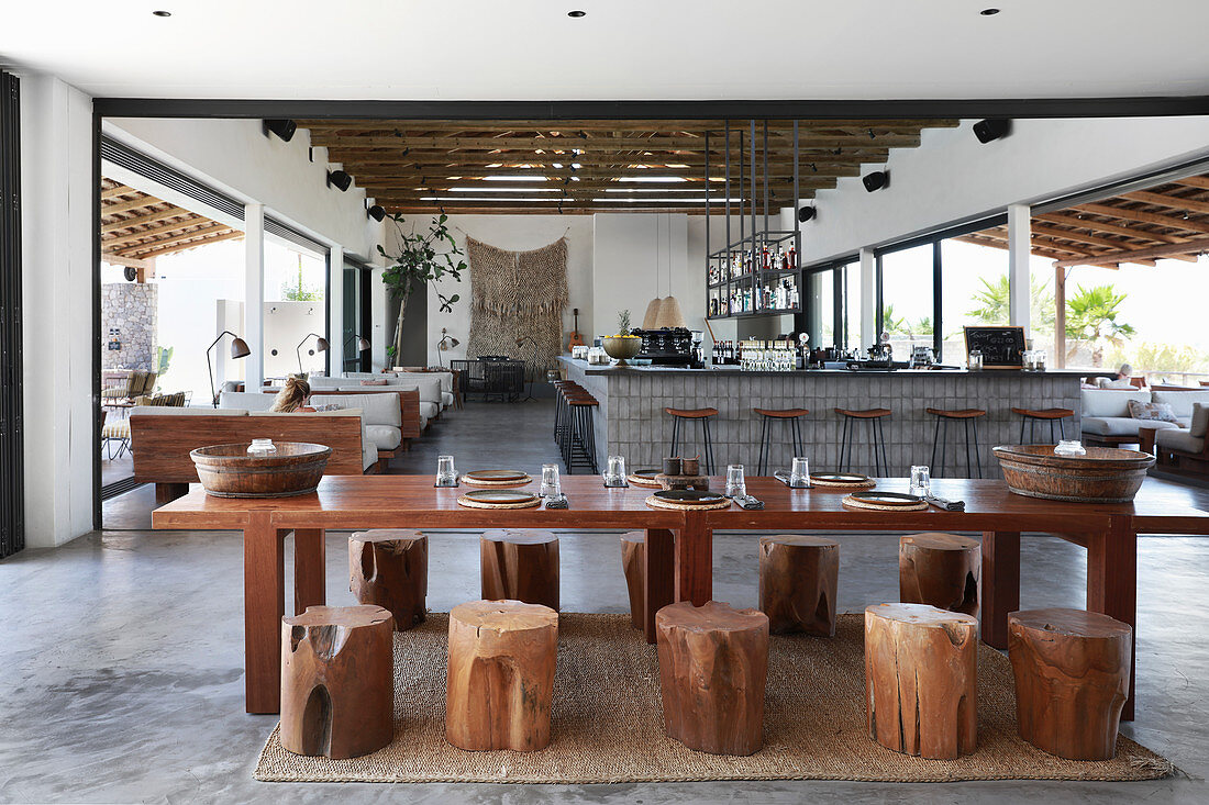 Set table with tree-stump stools in hotel lobby