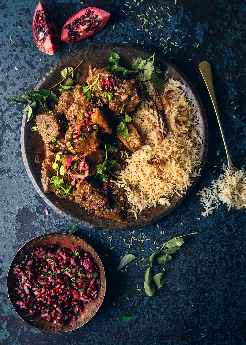 Indonesian rendang curry with fragrant spice rice and pomegranate raita