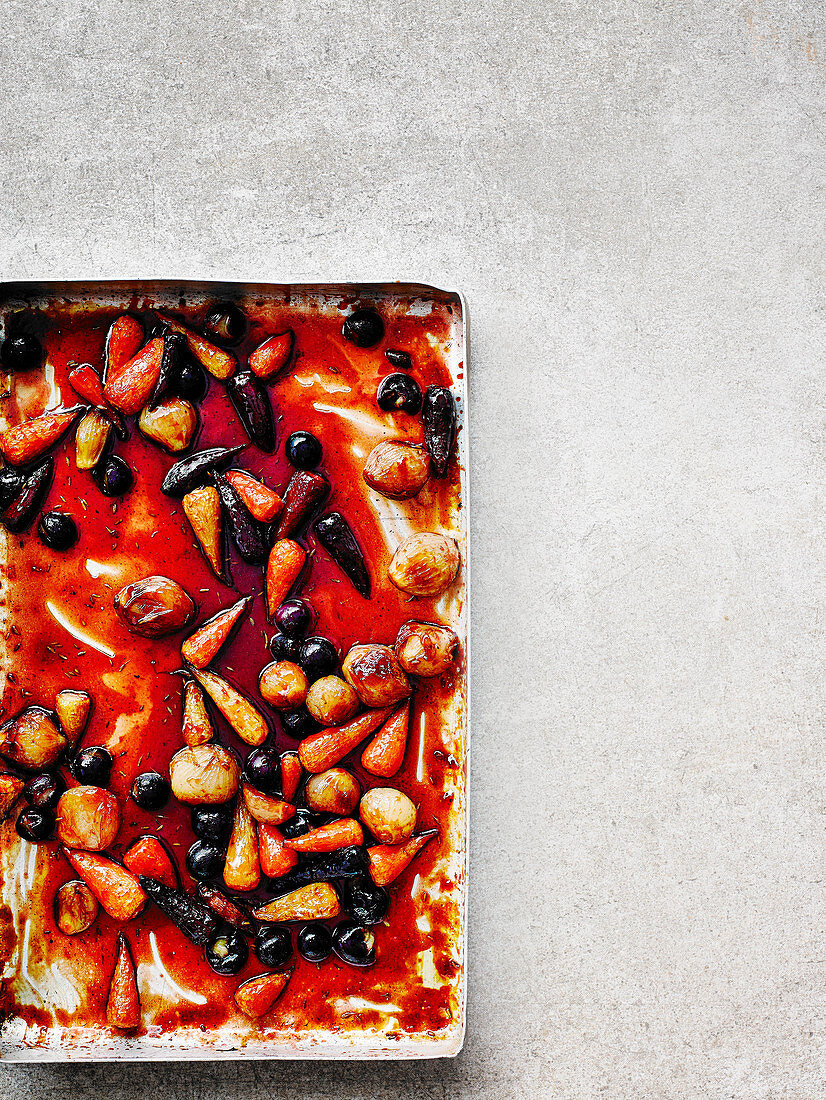 Pomegranate-glazed baby vegetables with grapes