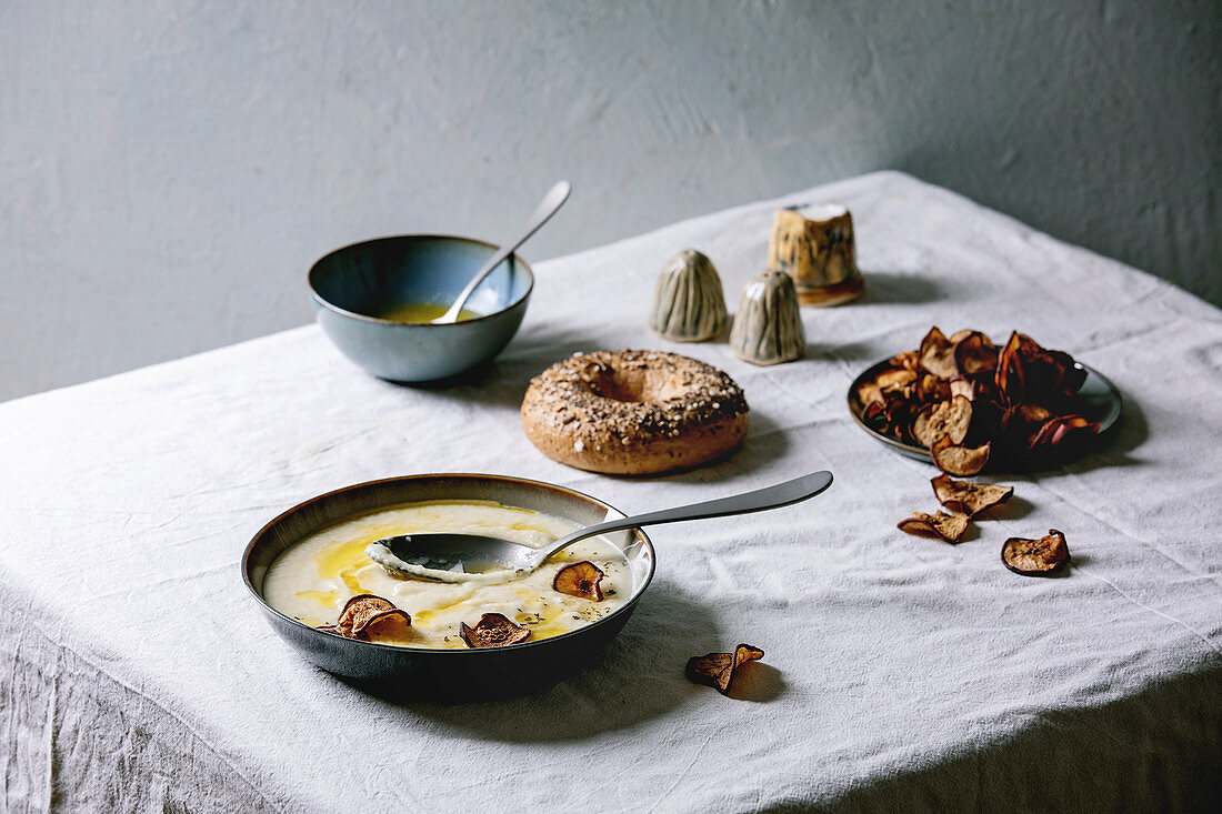 Blumenkohl-Pastinakensuppe mit getrockneten Birnenscheiben auf Tisch