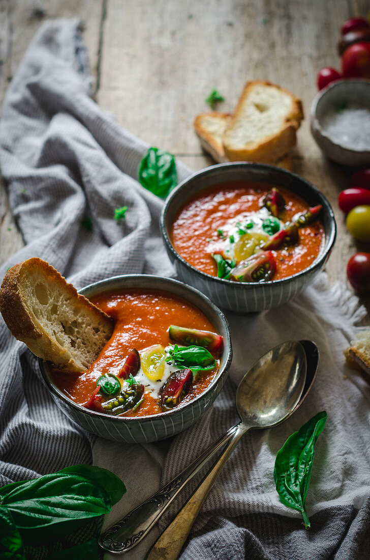 Fresh, homemade tomato soup on a rustic wooden table