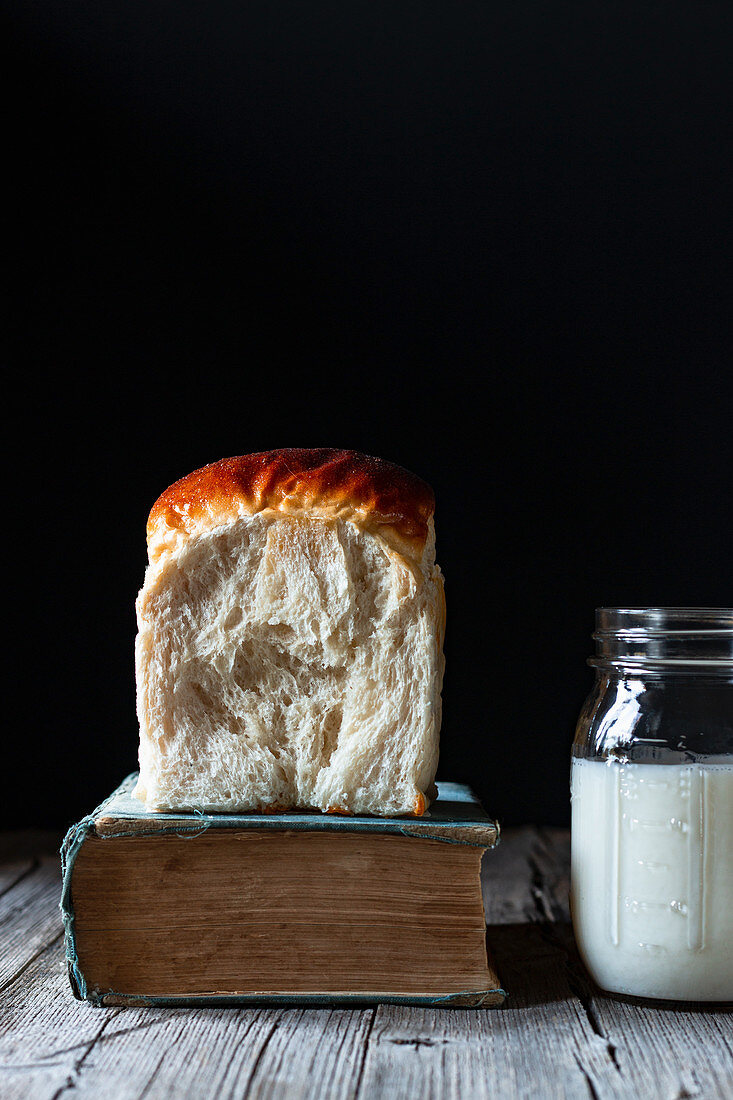 Buns of fresh bread on parchment placed on lumber table