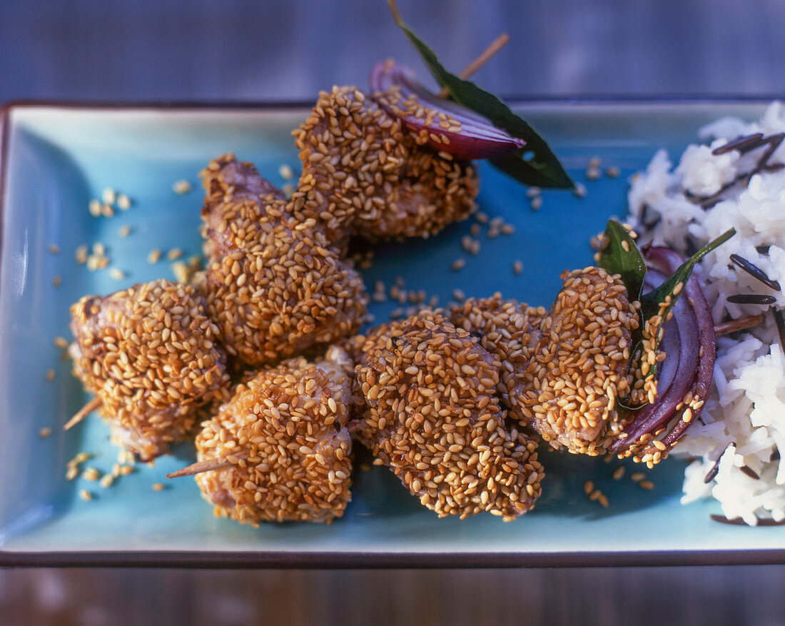 Fish skewers with sesame and rice