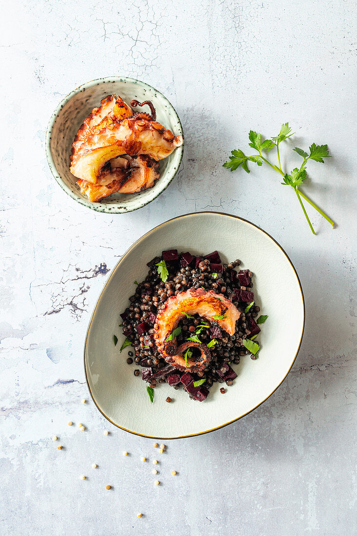 Black fregola (button pasta, Sardinia) with beetroot and squid