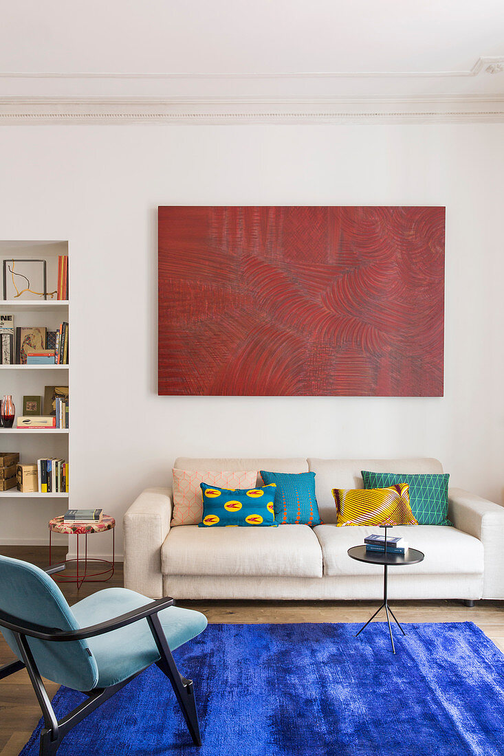 Abstract artwork above cream sofa in period apartment