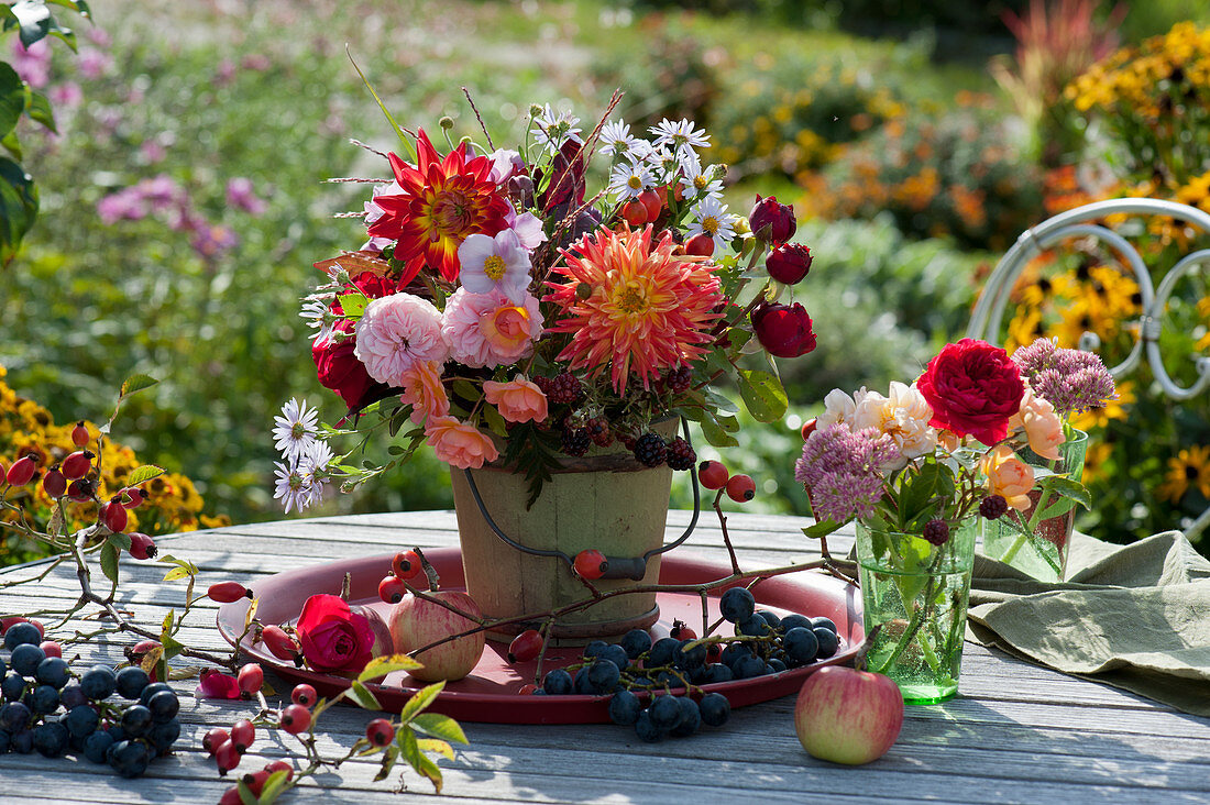 Bouquets of dahlias, roses, asters, and stonecrop, grapes, and rose hips as decoration