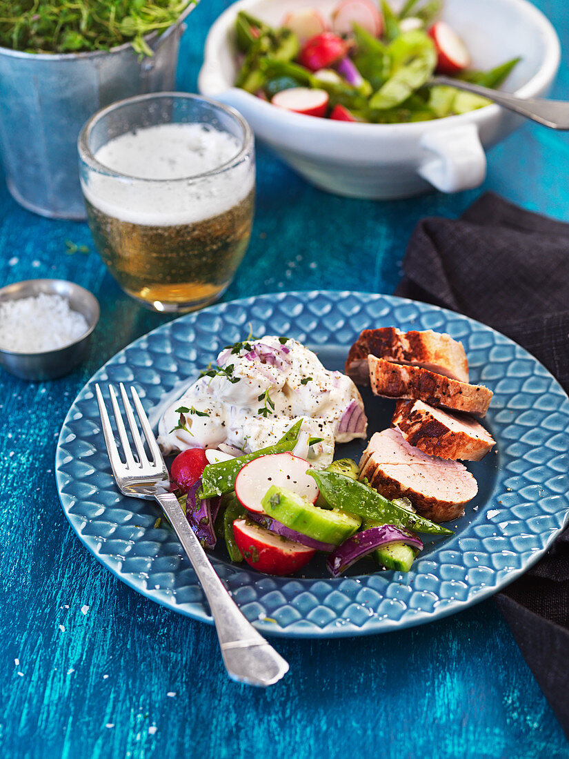 Pork fillet with raw vegetable and potato salad