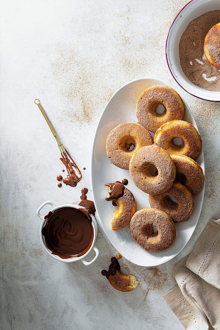 Baked donuts coated with cinnamon sugar and served with dipping chocolate sauce