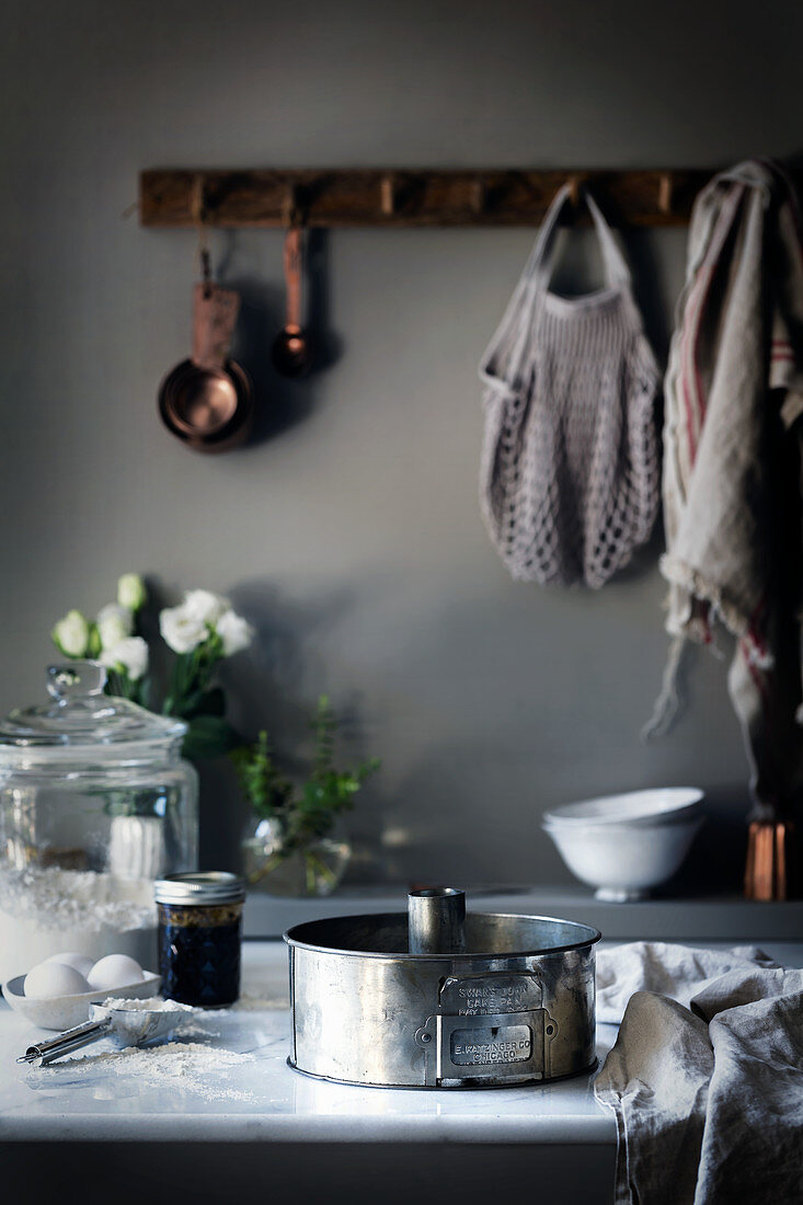 A baking dish and baking ingredients on a worktop in a rural kitchen