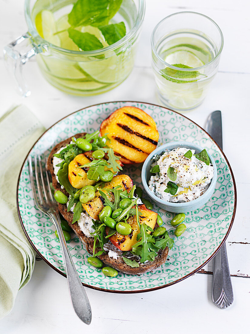 Grilled peach with edamame on bread