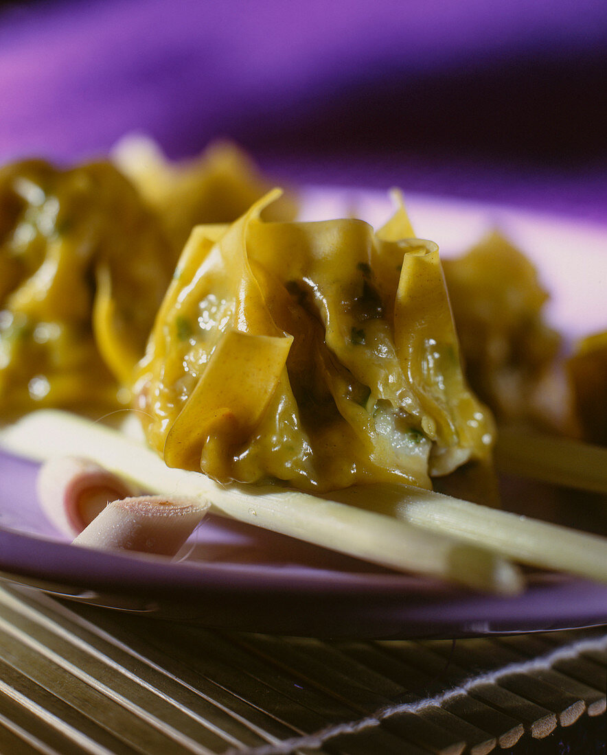 Asian pasta bag on chopsticks (close-up)