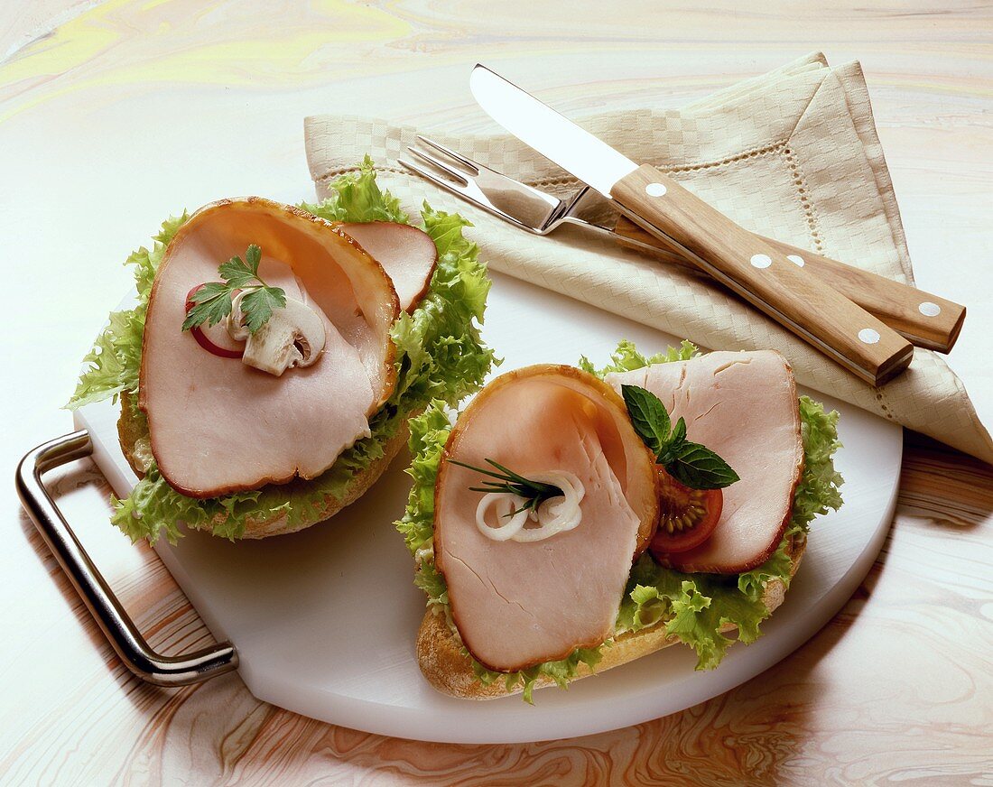 Bread rolls topped with lettuce & slices of turkey breast